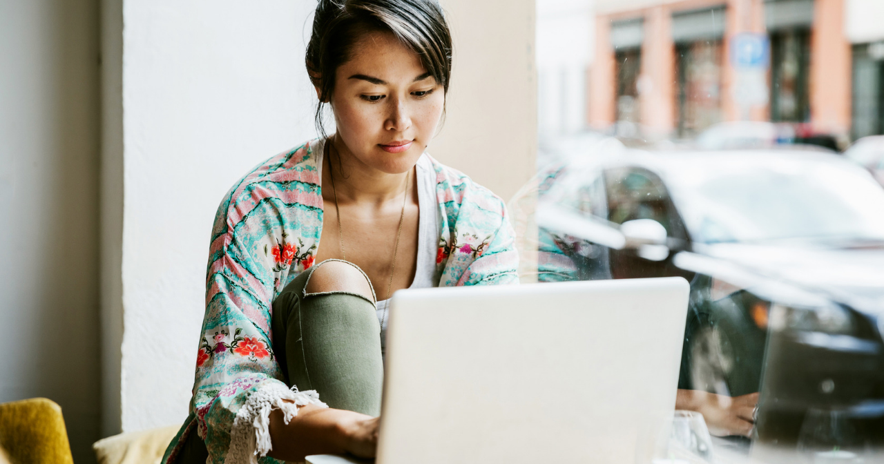 A woman sits calmly at her computer 