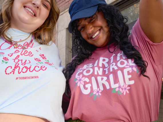 Two people wearing Power to Decide merch